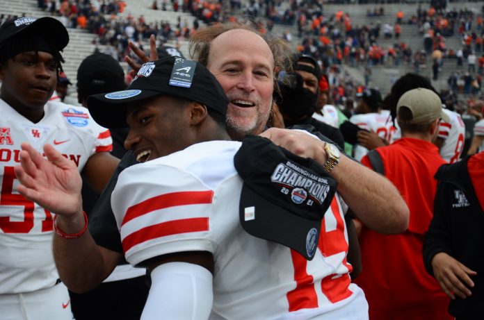 Dana Holgorsen embraced his players with lots of smiles and hugs to celebrate UH football